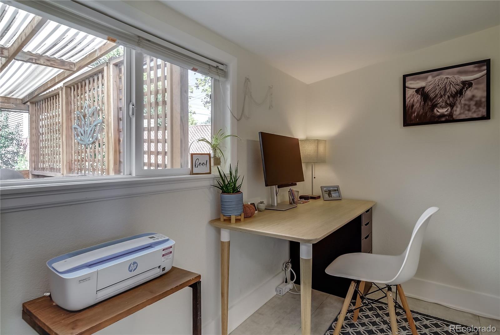 5129 Zuni Street Denver, CO 80221 - Photo 23 of 40 a view of a workspace with furniture and a window