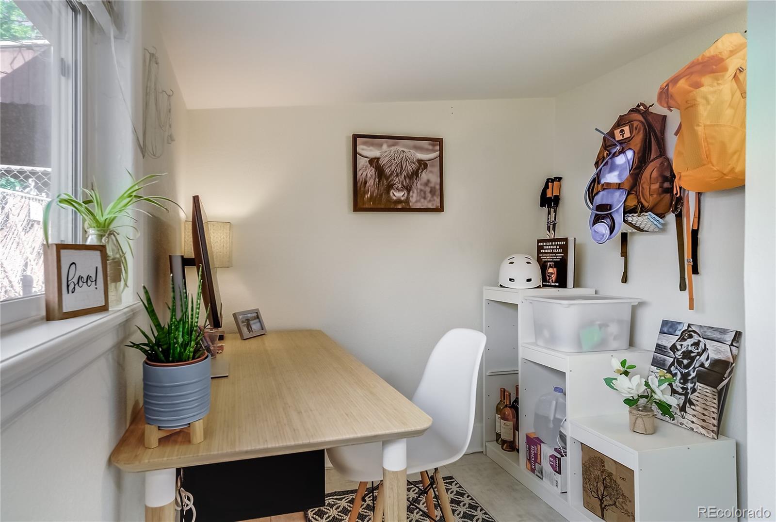 5129 Zuni Street Denver, CO 80221 - Photo 24 of 40 a dining room with furniture and flower vase
