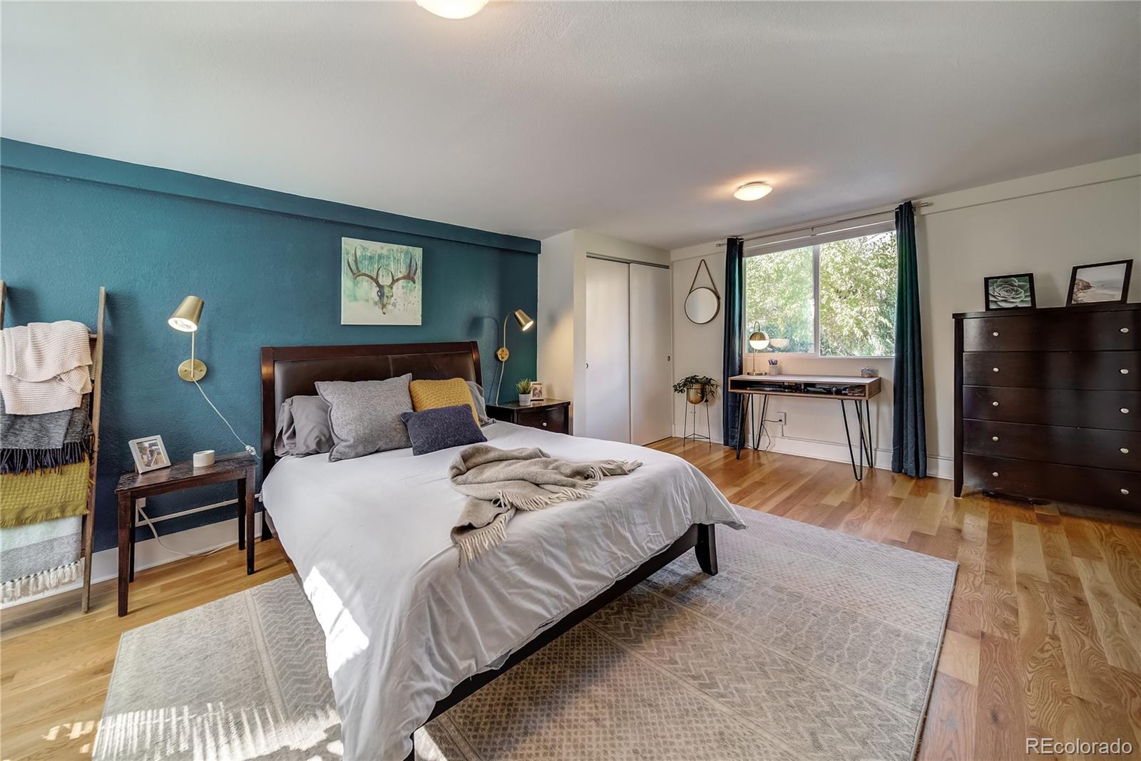 5129 Zuni Street Denver, CO 80221 - Photo 27 of 40 a bedroom with a bed and wooden floor