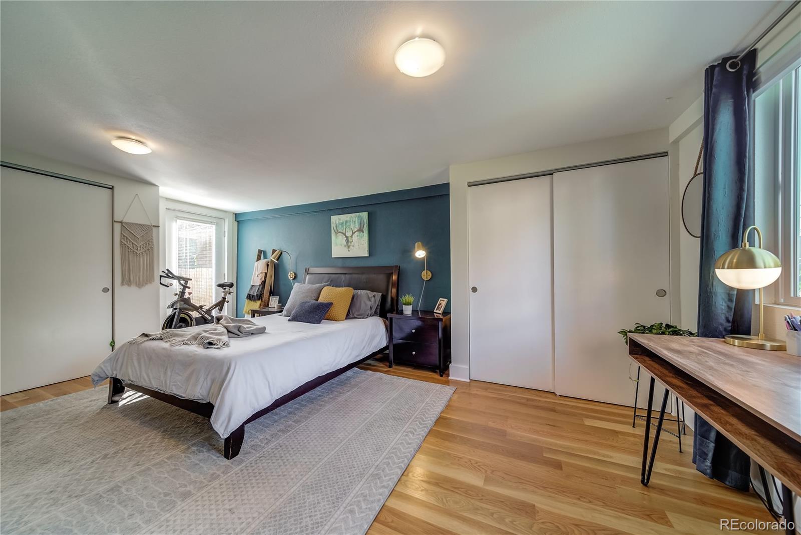 5129 Zuni Street Denver, CO 80221 - Photo 28 of 40 a bedroom with a bed and wooden floor