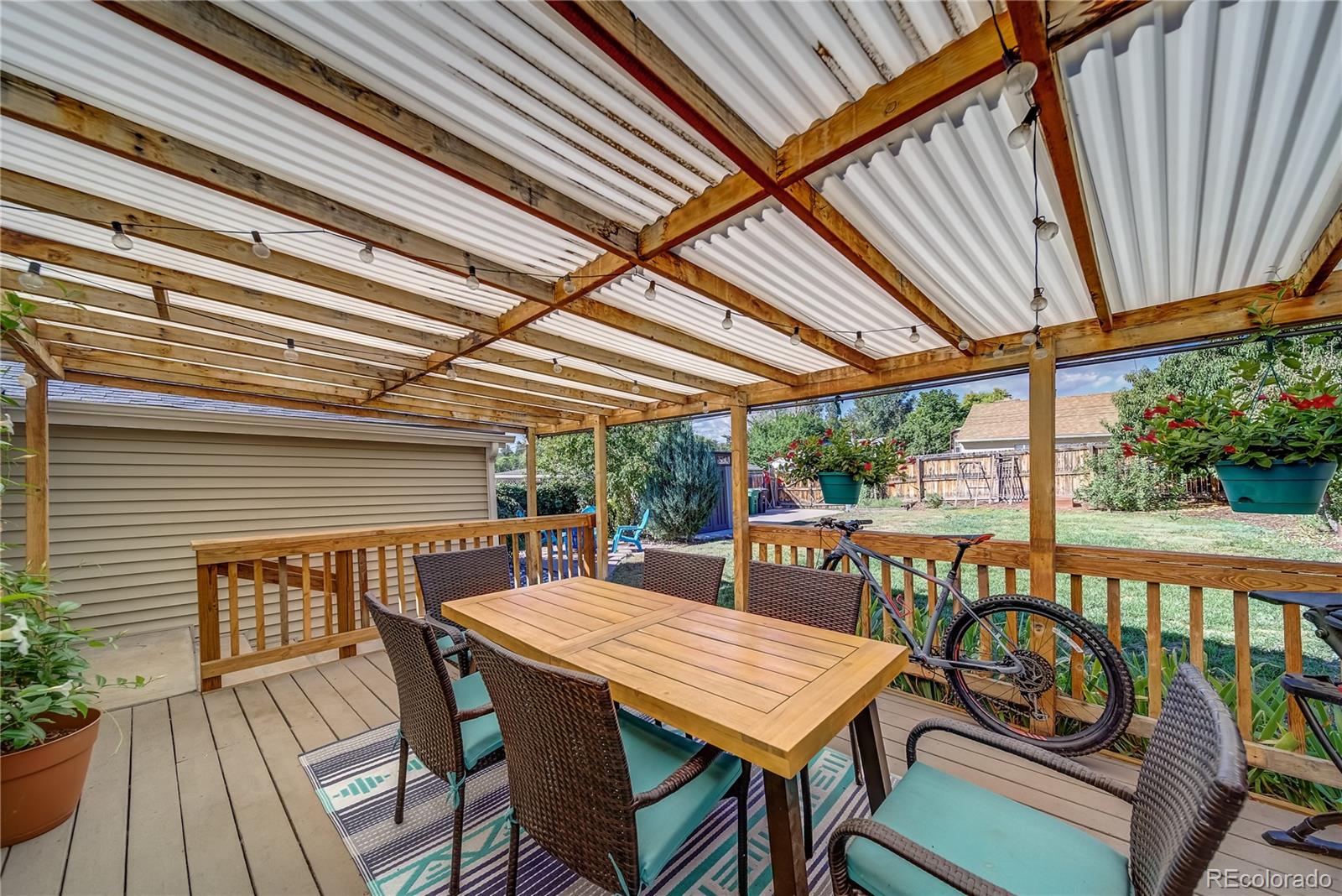 5129 Zuni Street Denver, CO 80221 - Photo 35 of 40 a view of a patio with table and chairs and wooden floor
