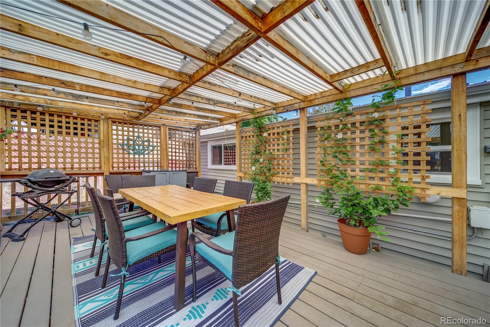 5129 Zuni Street Denver, CO 80221 - Photo 37 of 40 a roof deck with wooden floor and fence