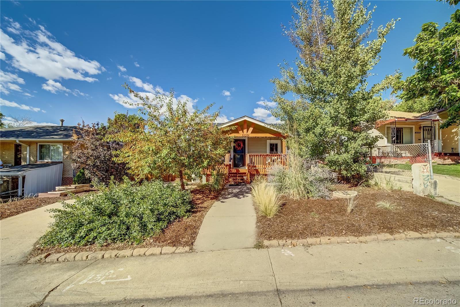5129 Zuni Street Denver, CO 80221 - Photo 40 of 40 a front view of a house with garden