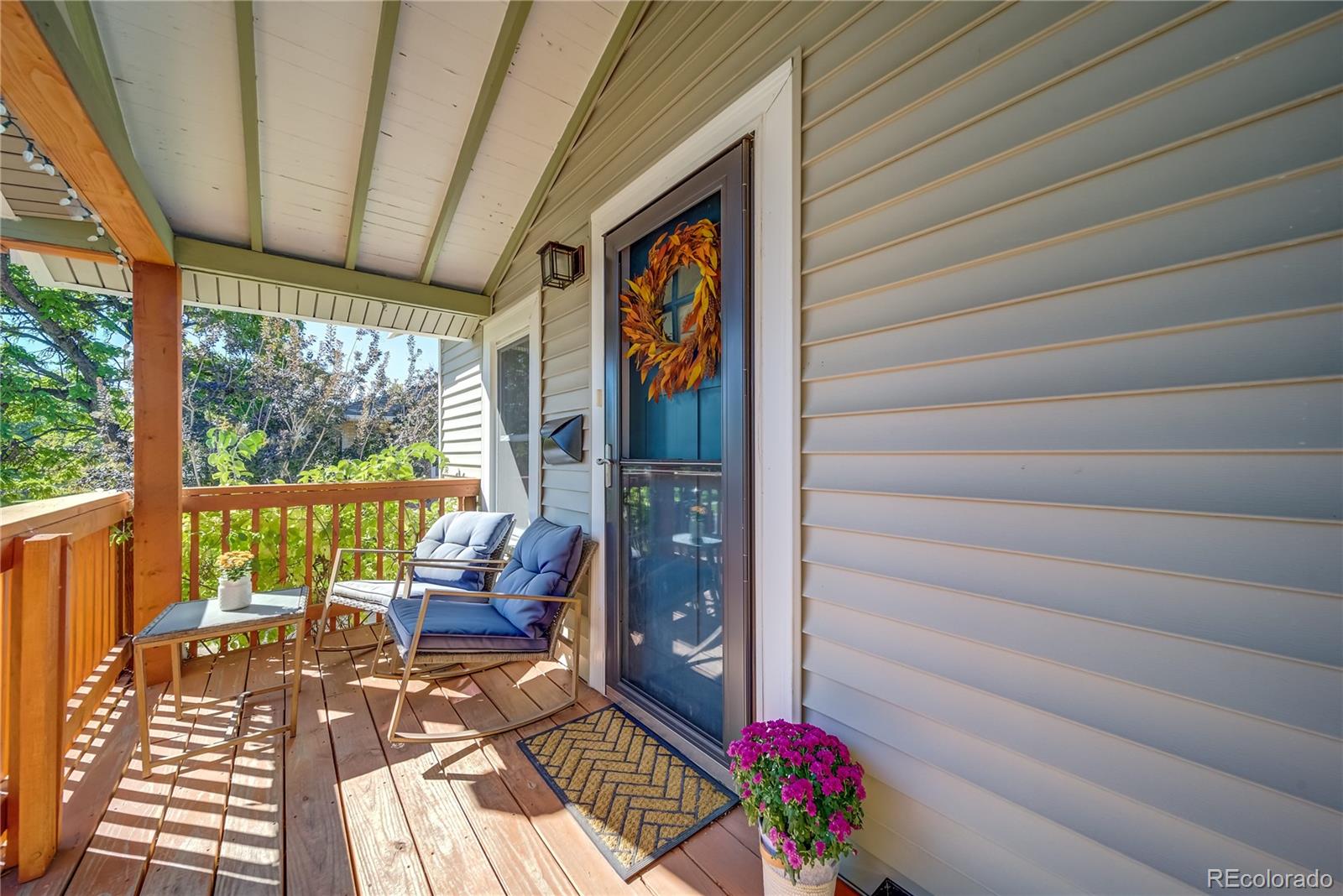 5129 Zuni Street Denver, CO 80221 - Photo 6 of 40 a view of a balcony with wooden floor and outdoor seating