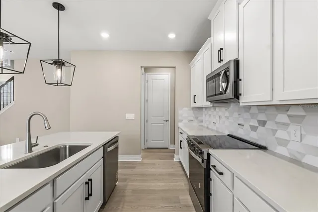 a kitchen with a sink and a stove top oven