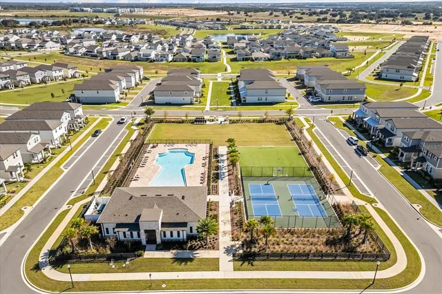 an aerial view of a swimming pool with outdoor seating