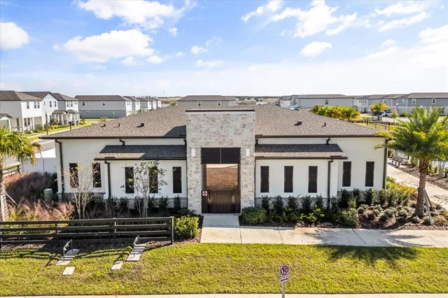 a view of house with swimming pool outdoor seating and lake view