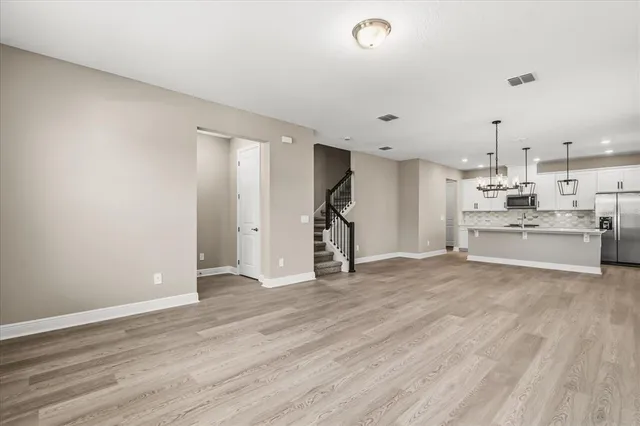 a view of a kitchen with wooden floor and a sink