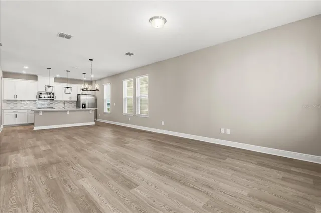 a view of a kitchen with wooden floor