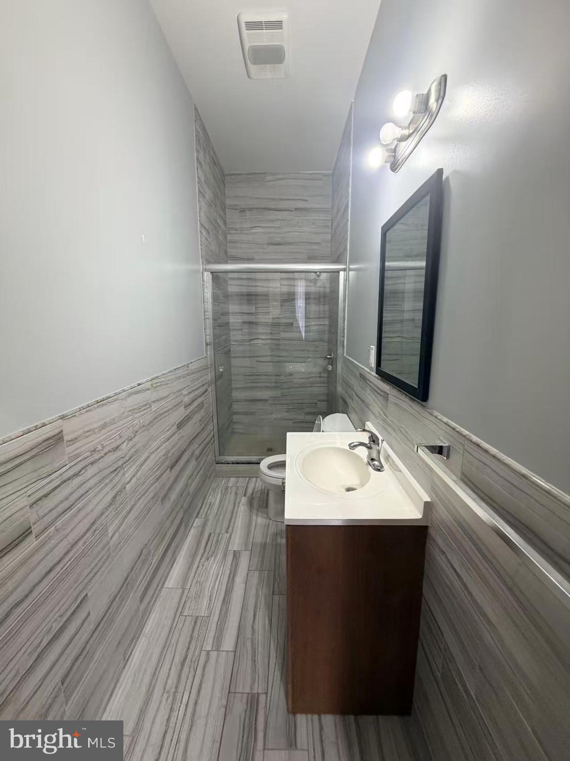 4428 Chestnut Street, Unit 2F Philadelphia, PA 19104 - Photo 2 of 7 a bathroom with a sink and a mirror