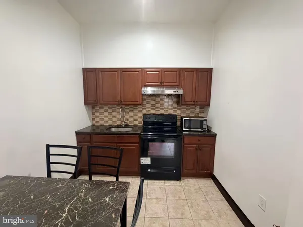 a kitchen with a stove and a refrigerator