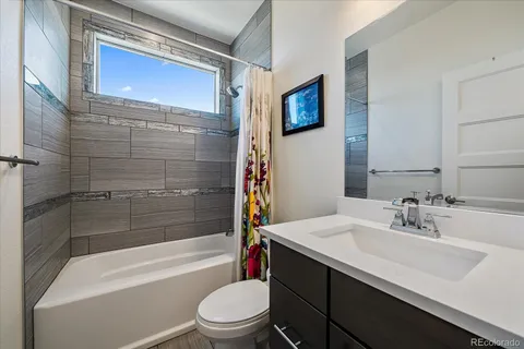 a view of a patio with couches table and chairs with wooden fence