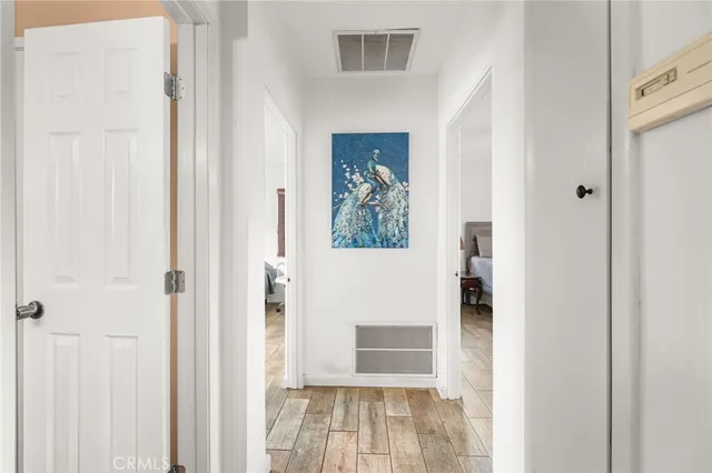 a view of a hallway with wooden floor and entryway