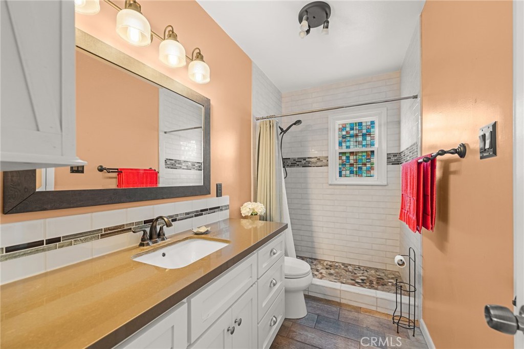 3620 Hoover Street Riverside, CA 92504 - Photo 15 of 44 a bathroom with a sink vanity granite and a toilet