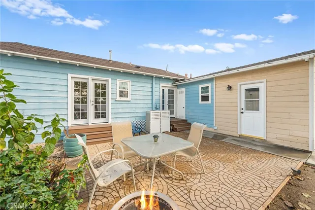 a backyard of a house with a table and chairs