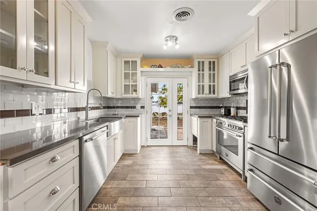 a kitchen with stainless steel appliances granite countertop a refrigerator and a sink