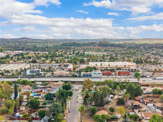 an aerial view of residential houses with outdoor space and lake view