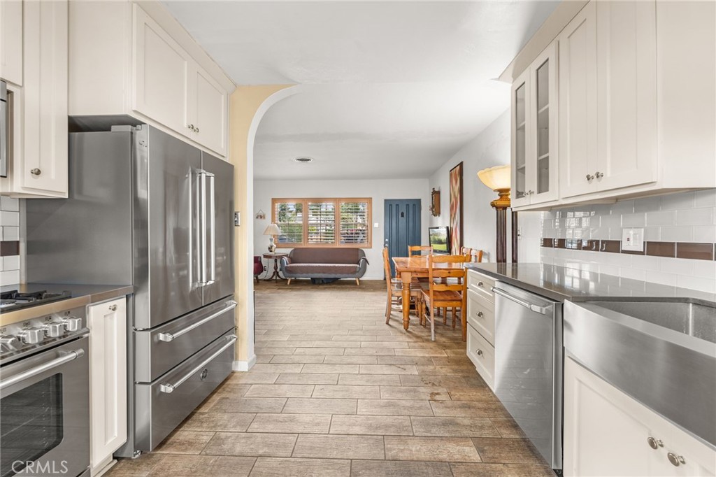 3620 Hoover Street Riverside, CA 92504 - Photo 6 of 44 a kitchen with stainless steel appliances granite countertop a refrigerator oven a sink dishwasher and cabinets with wooden floor
