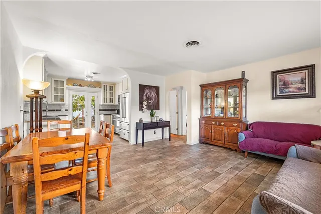 a living room with furniture a window and a flat screen tv