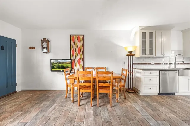 a dining room with furniture and wooden floor