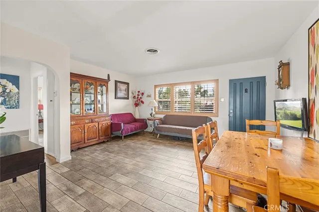 a bed room with furniture and a flat screen tv