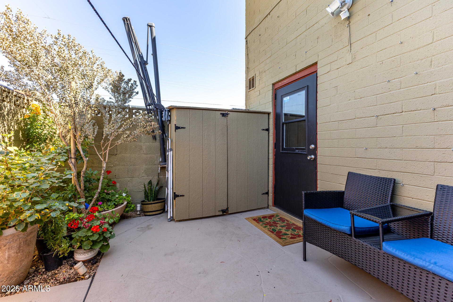 4615 North 39th Avenue, Unit 23 Phoenix, AZ 85019 - Photo 12 of 15 a backyard of a house with seating space