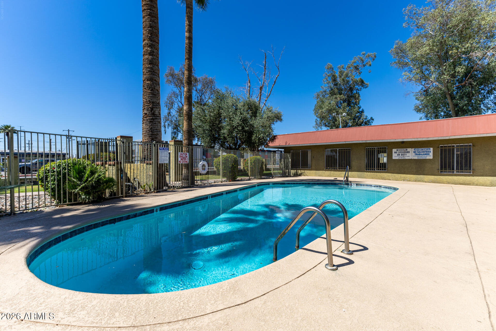 4615 North 39th Avenue, Unit 23 Phoenix, AZ 85019 - Photo 13 of 15 a view of swimming pool with seating space and yard in the back