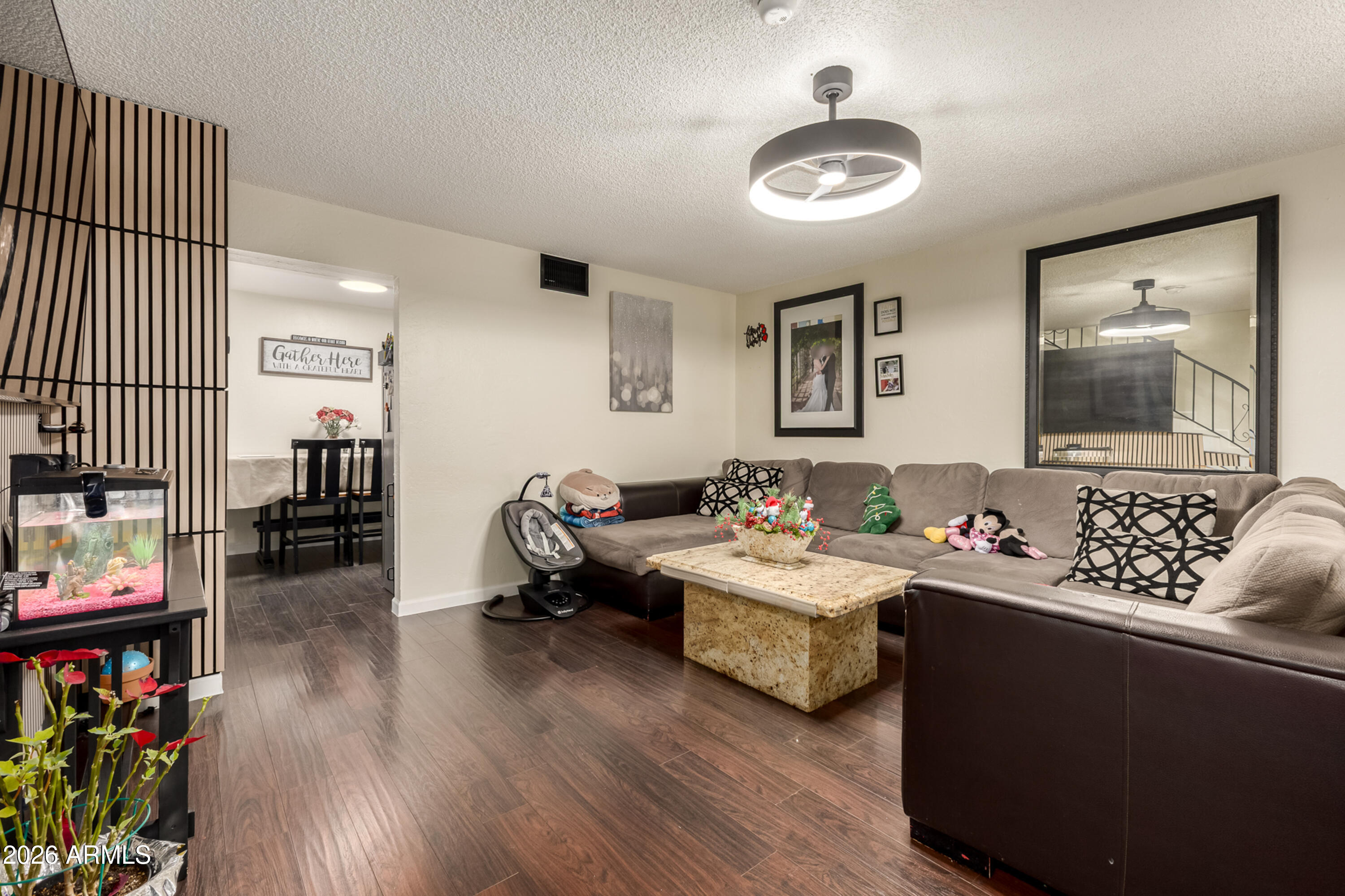 4615 North 39th Avenue, Unit 23 Phoenix, AZ 85019 - Photo 2 of 15 a living room with furniture and a wooden floor