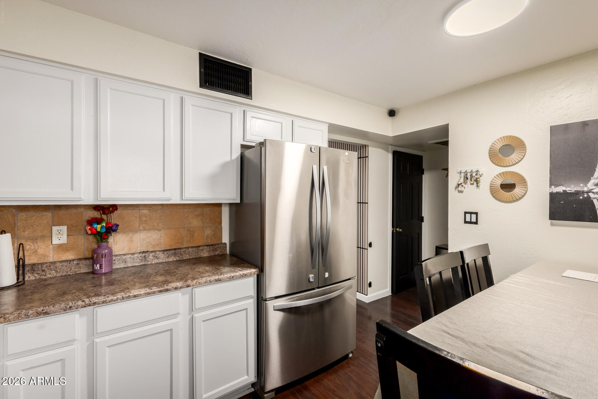 4615 North 39th Avenue, Unit 23 Phoenix, AZ 85019 - Photo 4 of 15 a kitchen with stainless steel appliances granite countertop a refrigerator a sink and white cabinets