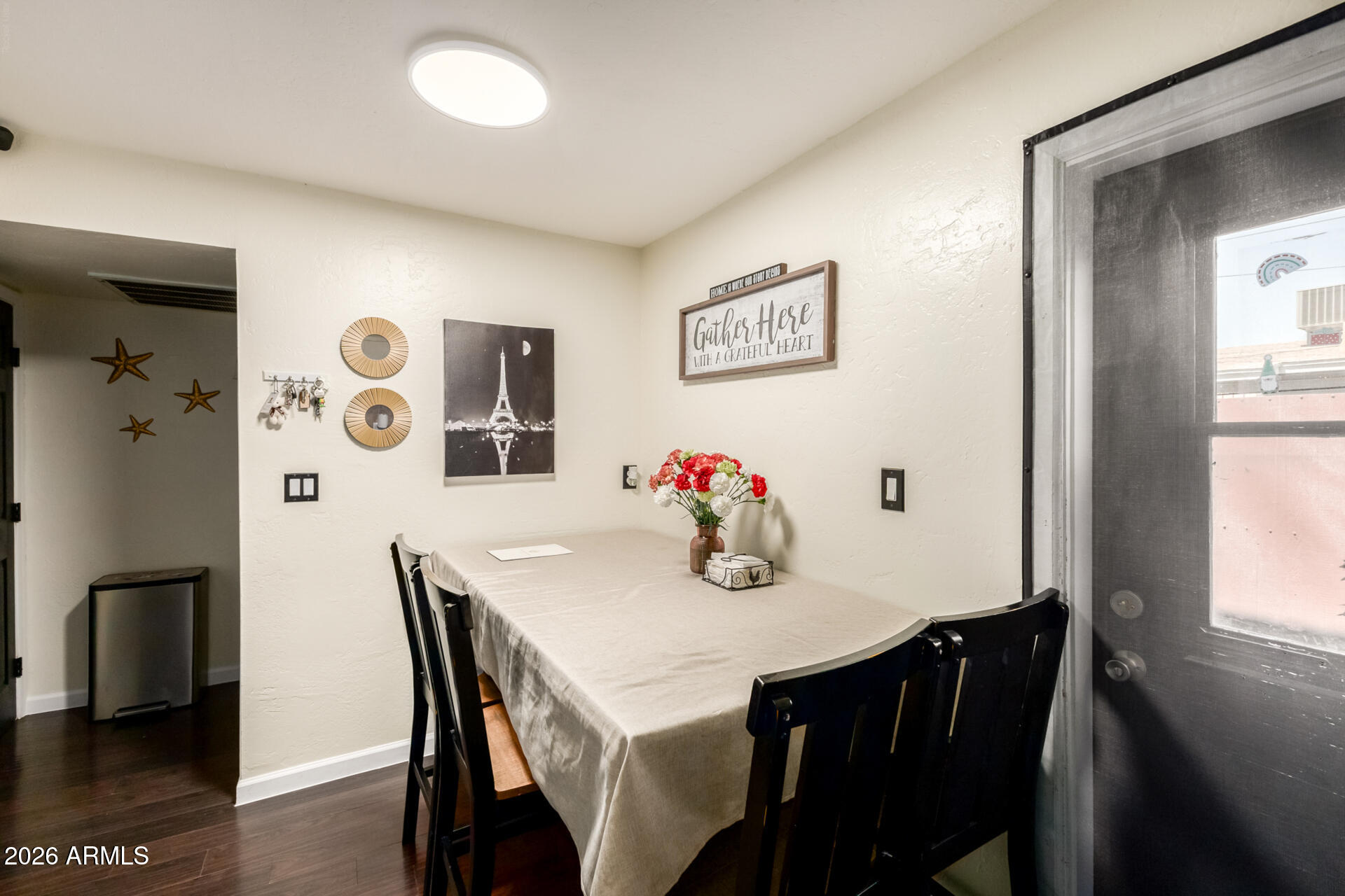 4615 North 39th Avenue, Unit 23 Phoenix, AZ 85019 - Photo 5 of 15 a view of a dining room with furniture and wooden floor