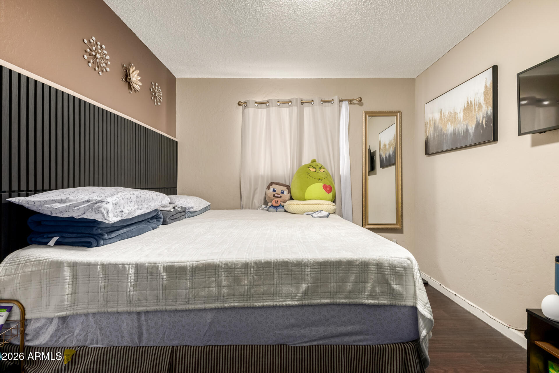 4615 North 39th Avenue, Unit 23 Phoenix, AZ 85019 - Photo 6 of 15 a bedroom with a bed and wooden floor