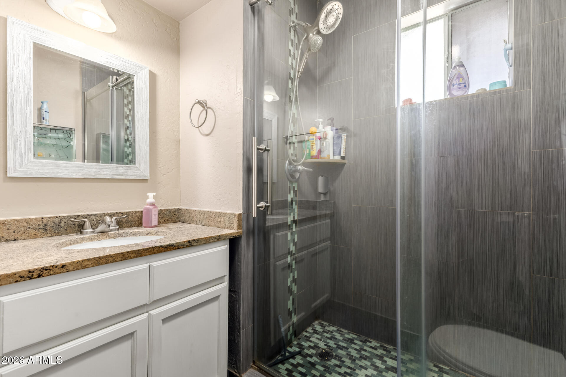 4615 North 39th Avenue, Unit 23 Phoenix, AZ 85019 - Photo 7 of 15 a bathroom with a granite countertop sink toilet and shower
