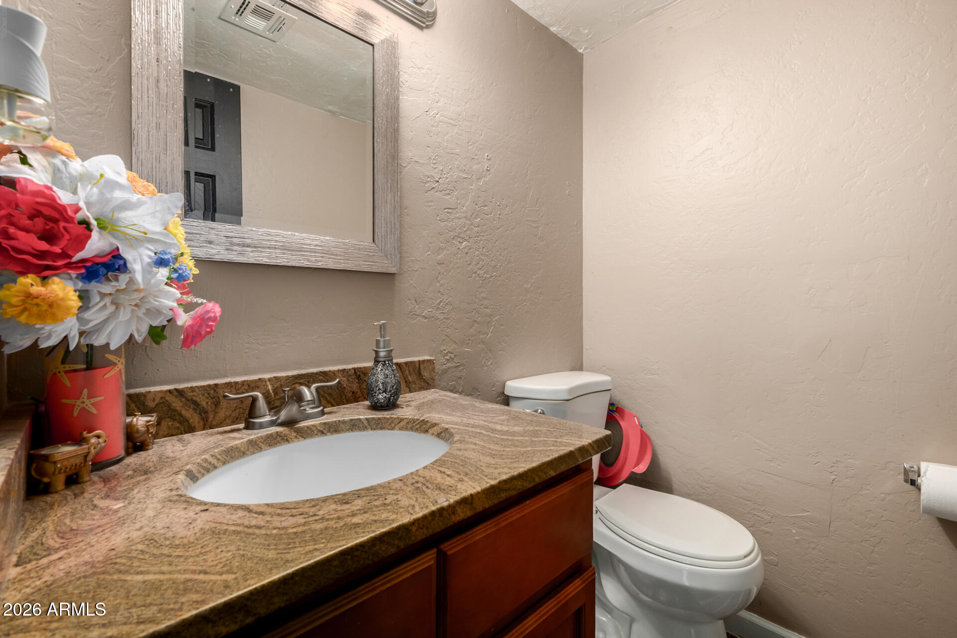 4615 North 39th Avenue, Unit 23 Phoenix, AZ 85019 - Photo 10 of 15 a bathroom with a granite countertop sink and a toilet