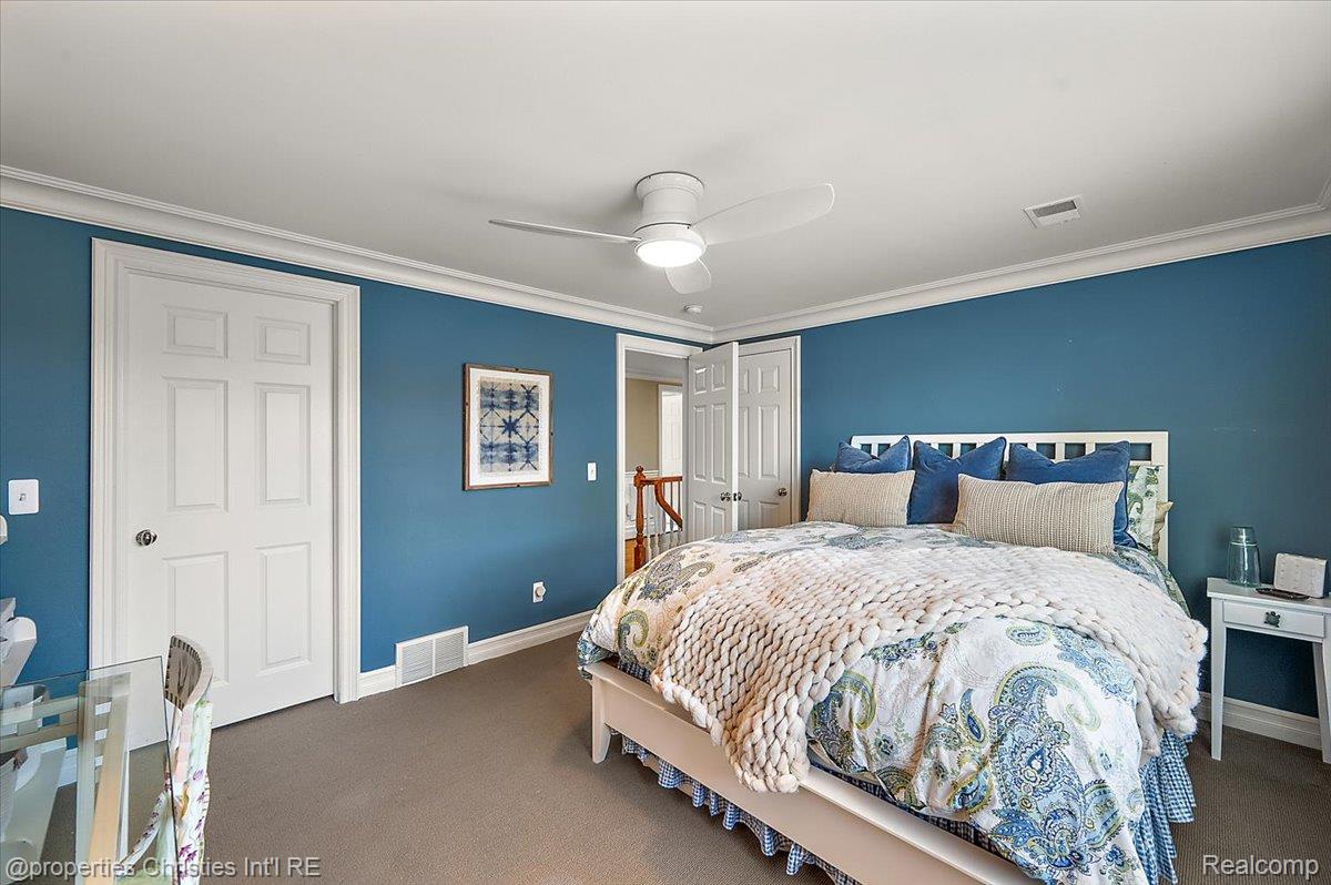 135 Clifton Road Bloomfield Hills, MI 48301 - Photo 60 of 77 Room featuring wall-to-wall carpeting, crown molding, and two six-panel doors