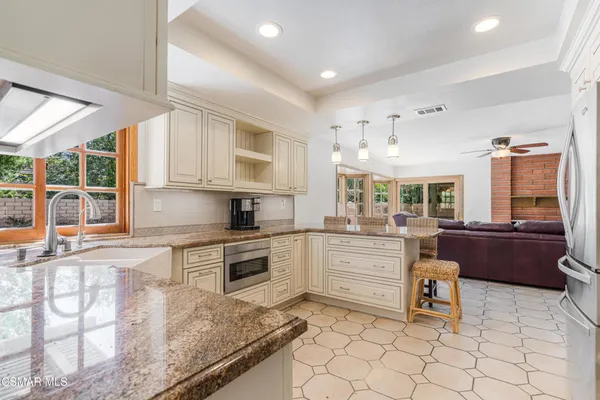 a kitchen with sink cabinets and dining table