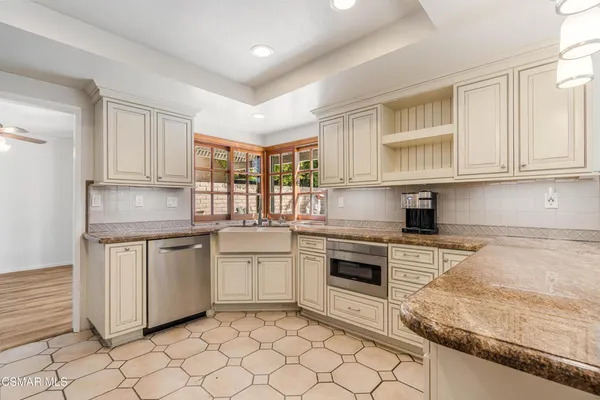 a kitchen with granite countertop cabinets stainless steel appliances and a sink