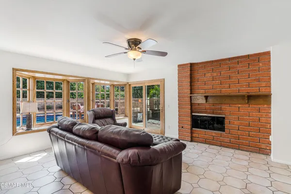 a living room with furniture windows and a fireplace