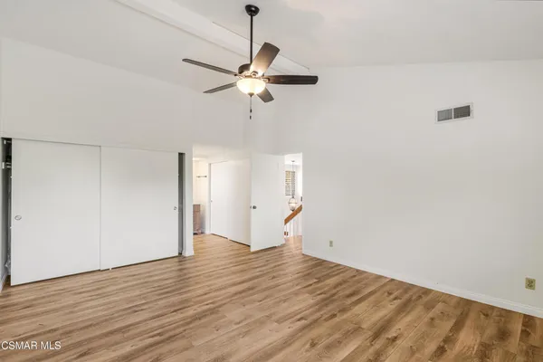 a view of empty room with wooden floor