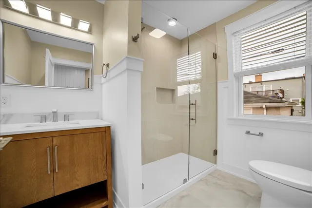 a bathroom with a granite countertop sink toilet and shower