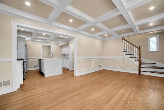 a view of a livingroom with wooden floor and furniture
