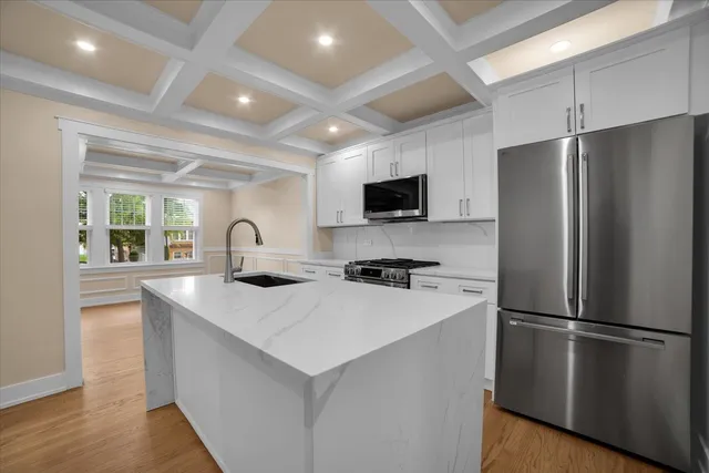 a kitchen with stainless steel appliances a refrigerator stove microwave and sink