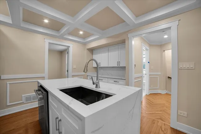 a kitchen that has a sink and a stove in it