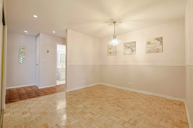 a kitchen that has a dining table chairs and refrigerator