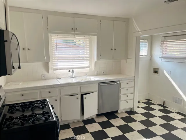 a kitchen with a stove a sink and a refrigerator