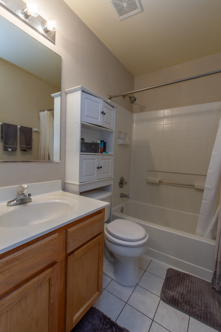 10909 Cape Cod Lane Huntley, IL 60142 - Photo 15 of 18 a bathroom with a sink toilet and shower