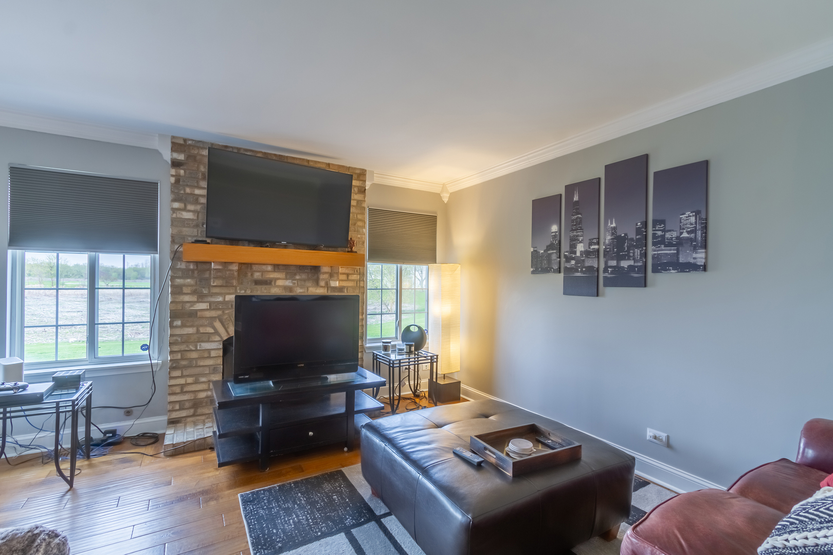 10909 Cape Cod Lane Huntley, IL 60142 - Photo 3 of 18 a living room with furniture a flat screen tv and a fireplace