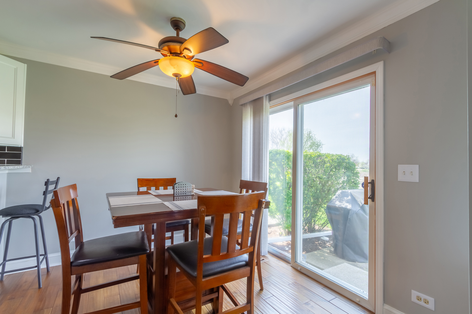 10909 Cape Cod Lane Huntley, IL 60142 - Photo 5 of 18 a dining room with furniture a chandelier and wooden floor