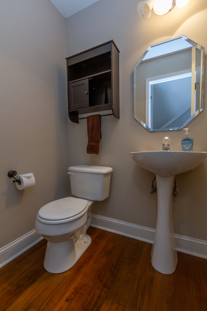 10909 Cape Cod Lane Huntley, IL 60142 - Photo 10 of 18 a bathroom with a toilet sink and mirror