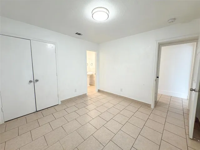 a view of an empty room and wooden floor