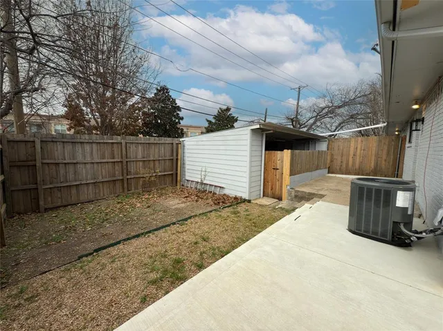 a backyard of a house with table and chairs